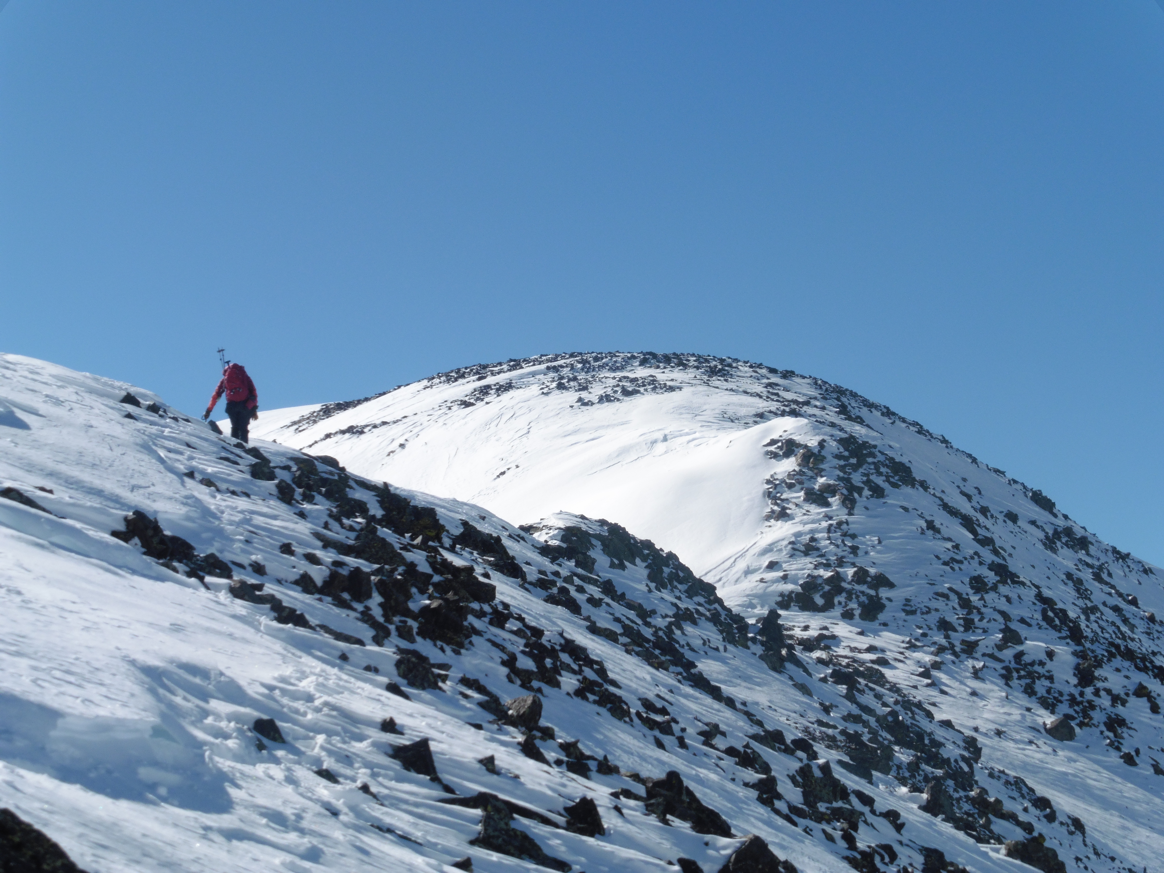 Colin gaining the summit ridge on 12,780B. The corniced knife edge is just beyond the bump that's seen.